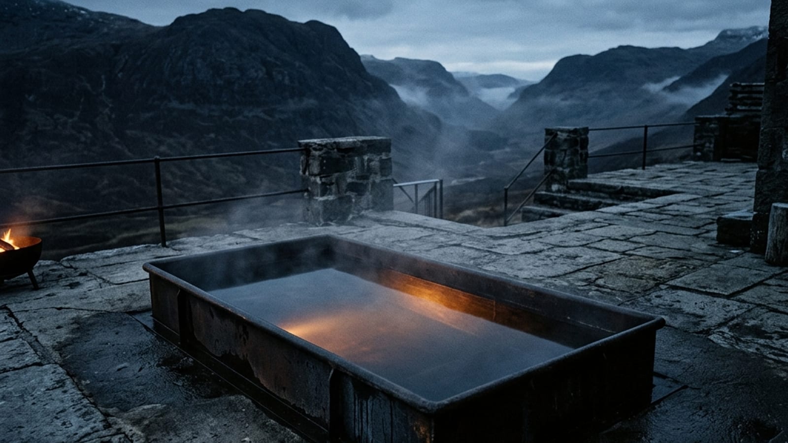 A person standing at the edge of a steel cold plunge tub in dim stone-lit surroundings, steadying themselves before entering